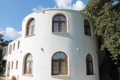 a white building with windows on the side of it at Pataki Guesthouse in Petrovac na Moru