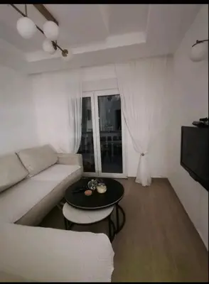 a living room with a white couch and a table at Apartman Budva in Budva