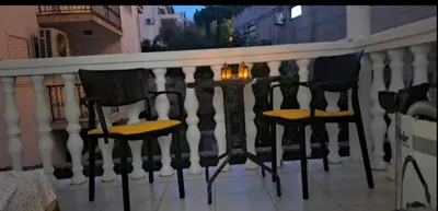 a group of chairs sitting on a balcony at Apartman Budva in Budva