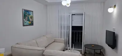a living room with a couch and a tv at Apartman Budva in Budva