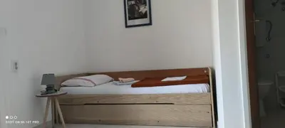 a bedroom with a bed with a wooden frame at House Irena in Budva