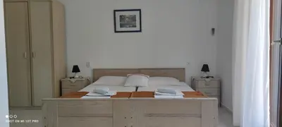 a bedroom with a bed and a desk with two lamps at House Irena in Budva