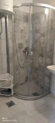 a shower with a glass door in a bathroom at House Irena in Budva