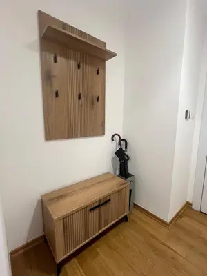 a room with a wooden bench and a mirror on the wall at Luxury Apartment SOHO CITY in Bar