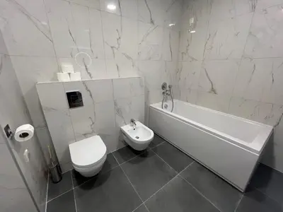 a bathroom with a toilet and a tub and a sink at Luxury Apartment SOHO CITY in Bar
