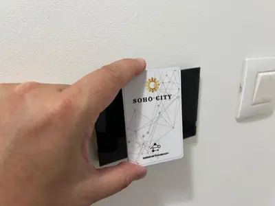 a hand holding a solar city card in a lightswitch at Luxury Apartment SOHO CITY in Bar