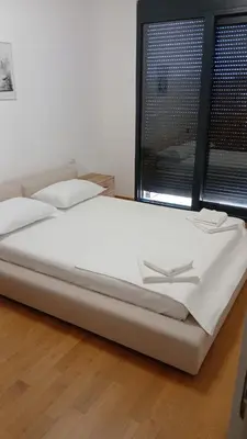 a large white bed in a room with a window at Luxury Apartment SOHO CITY in Bar