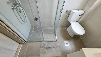 a bathroom with a toilet and a glass shower at Zero Distance Studio in Podgorica