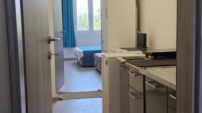 a small room with a kitchen with a window at Zero Distance Studio in Podgorica