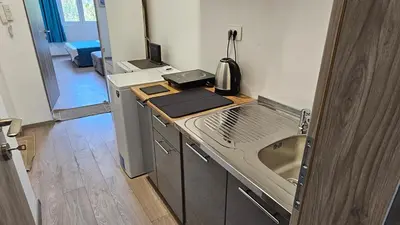 a kitchen with a stove and a sink in a room at Zero Distance Studio in Podgorica