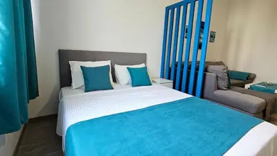 a bedroom with a large bed and a couch at Zero Distance Studio in Podgorica