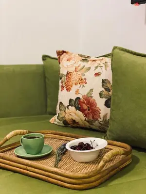 a tray with a bowl of fruit and a cup on a couch at Junto al mar in Ulcinj