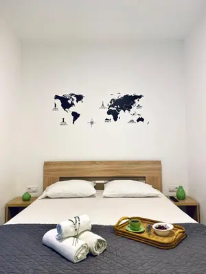 a bedroom with a bed with a map of the world on the wall at Junto al mar in Ulcinj