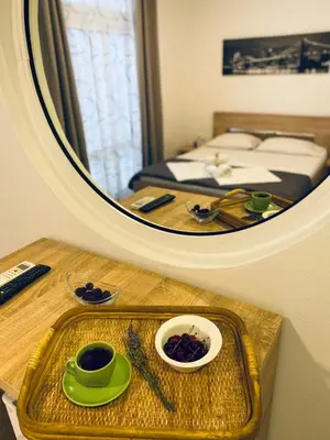a mirror reflection of a bedroom with a table and a bed at Junto al mar in Ulcinj