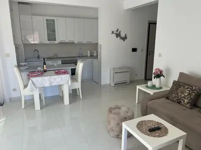 a living room with a couch and a table and a kitchen at Hidden Gem, Budva in Budva