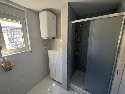 a bathroom with a shower and a sink and a window at Hidden Gem, Budva in Budva