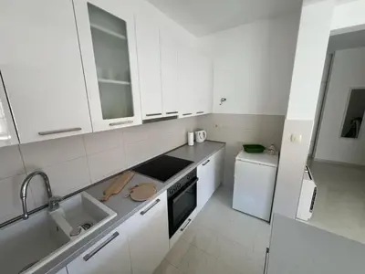 a white kitchen with white cabinets and a sink at Hidden Gem, Budva in Budva