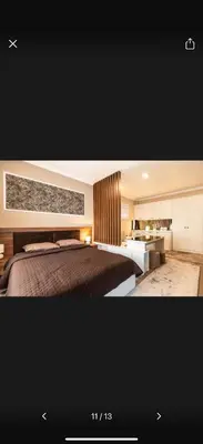a bedroom with a large bed and a bathroom at Little star in Ulcinj