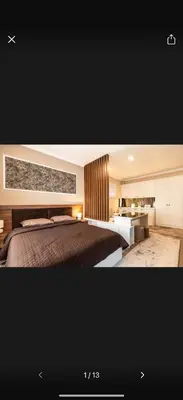 a bedroom with a large bed and a bathroom at Little star in Ulcinj