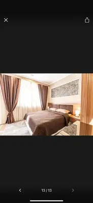 a picture of a bedroom with a bed and curtains at Little star in Ulcinj