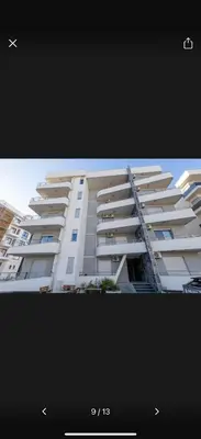 a large white apartment building with a picture of it at Little star in Ulcinj