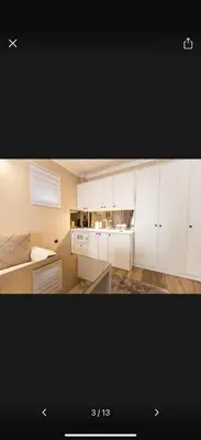 a kitchen with white cabinets and a counter top at Little star in Ulcinj