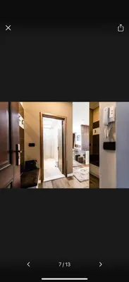 a kitchen with a refrigerator and a door to a room at Little star in Ulcinj