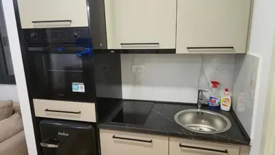 a small kitchen with a sink and a microwave at LIMONCELLO Apartment in Bar