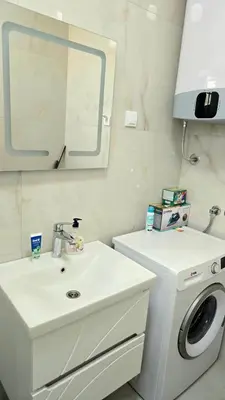 a bathroom with a sink and a washing machine at LIMONCELLO Apartment in Bar