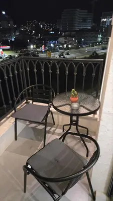 a table and chairs on a balcony with a view at LIMONCELLO Apartment in Bar