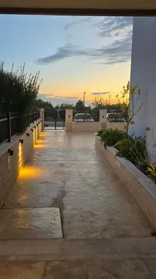 a walkway with lights on the side of a building at LIMONCELLO Apartment in Bar