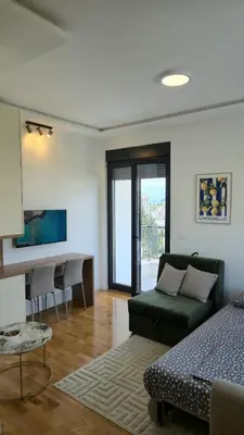 a living room with a couch and a desk at LIMONCELLO Apartment in Bar