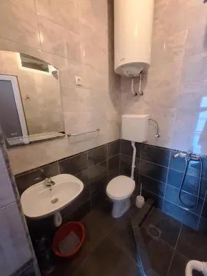 a bathroom with a toilet and a sink at Apartmani Miladinović in Sutomore