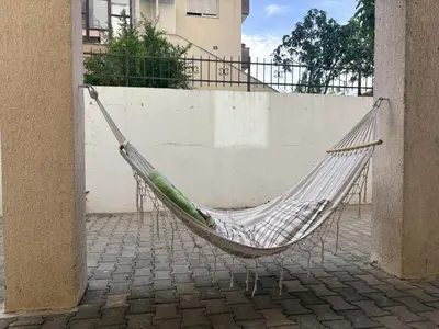 a hammock hanging from a wall next to a building at Apartman Sunce in Podgorica