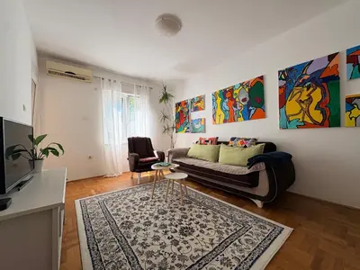 a living room with a couch and a table at Apartman Sunce in Podgorica