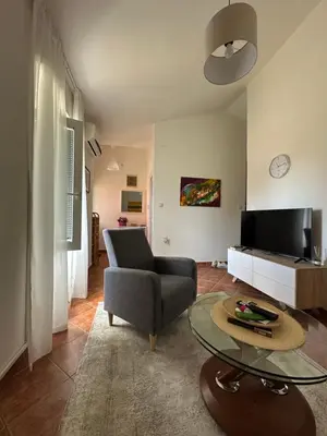 a living room with a chair and a table at Stari Bar Apartments in Stari Bar