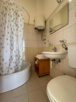 a bathroom with a tub and a sink and a toilet at Stari Bar Apartments in Stari Bar