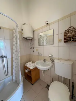 a bathroom with a toilet and a sink and a tub at Stari Bar Apartments in Stari Bar