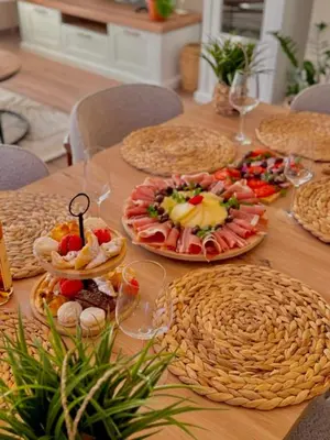 a table with many plates of food on it at Villa Lotos in Budva