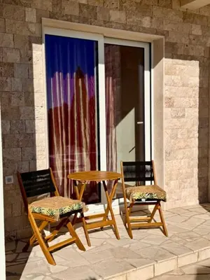 two chairs and a table on a patio at Villa Lotos in Budva