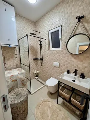 a bathroom with a shower and a toilet and a sink at Villa Lotos in Budva