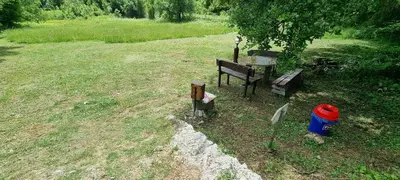 a picnic table and a bench in a field at Livari CAMPING in Livari