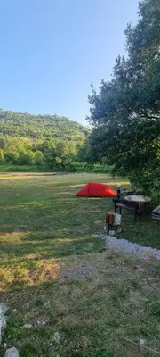a picnic table and a tent in a field at Livari CAMPING in Livari
