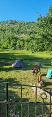 a tent and a bike parked in a field at Livari CAMPING in Livari
