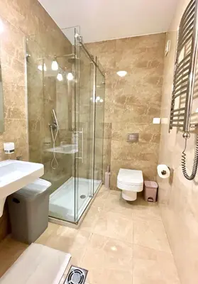 a bathroom with a shower and a toilet and a sink at Podgorica Apartment Center in Podgorica