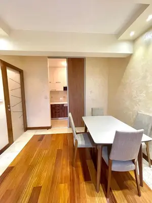 a kitchen and dining room with a table and chairs at Podgorica Apartment Center in Podgorica
