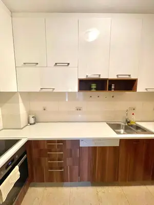 a kitchen with white cabinets and a sink at Podgorica Apartment Center in Podgorica