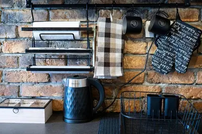 a brick wall with a coffee pot on a table at Podgorica Boulevard Residence in Podgorica
