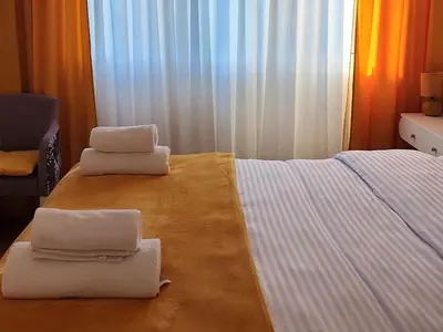 a bedroom with two stacks of towels on a bed at Podgorica Boulevard Residence in Podgorica