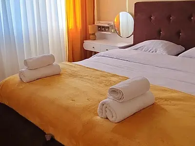 a bedroom with a bed with towels on it at Podgorica Boulevard Residence in Podgorica
